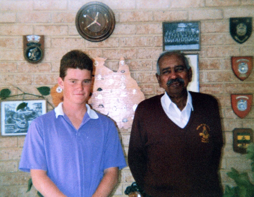 A younger and an older man photographed together.