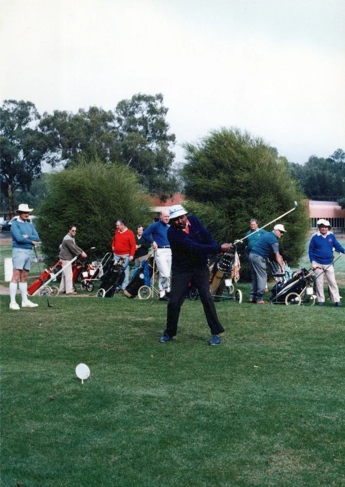 Players on a lawn during an outdoor game.