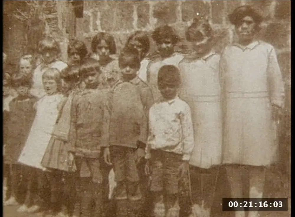 A group gathered outside a hall.