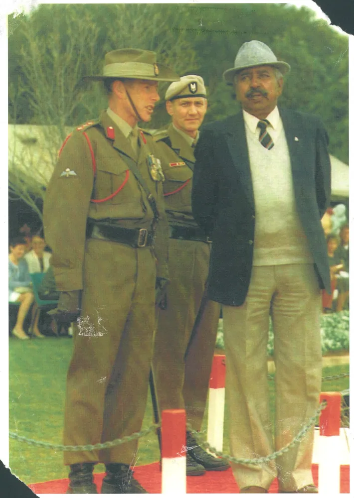 Two men photographed in a garden, one in service dress.