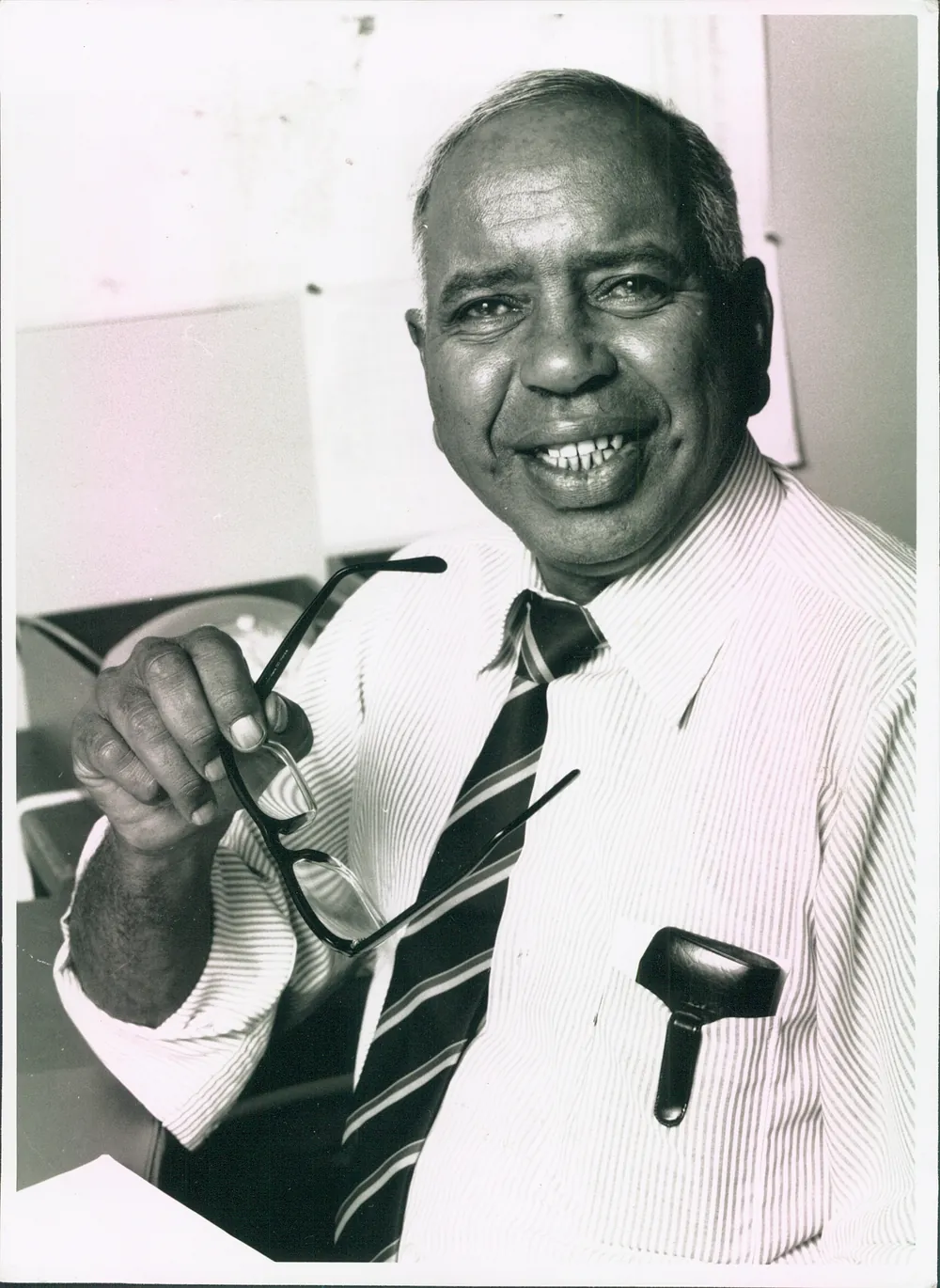 Studio portrait holding a pipe.