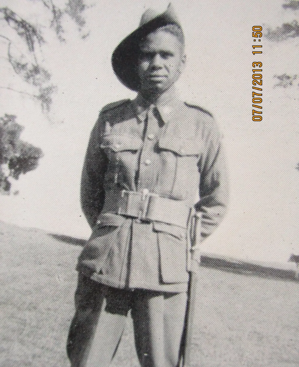 A soldier standing in full kit.