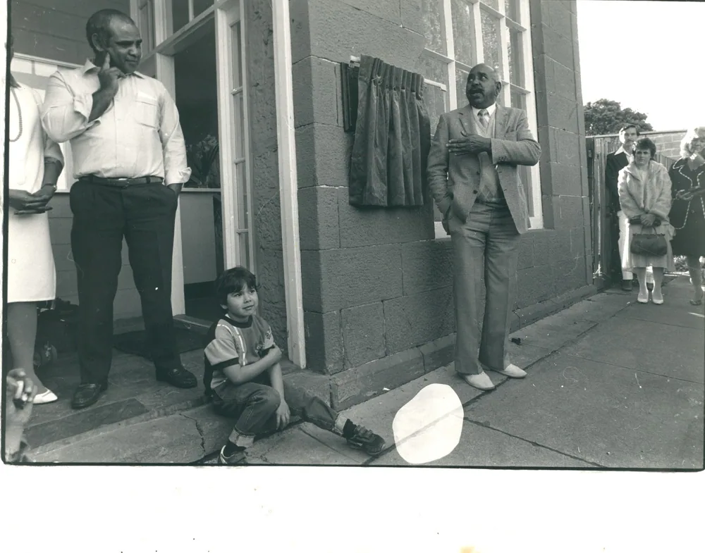 A street scene with people on a veranda.