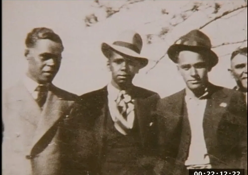 Three men photographed together in an early sepia print.