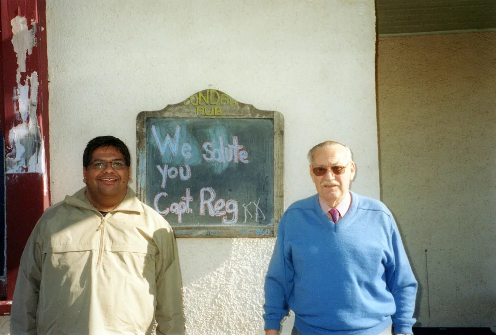 A couple beside a welcome board.