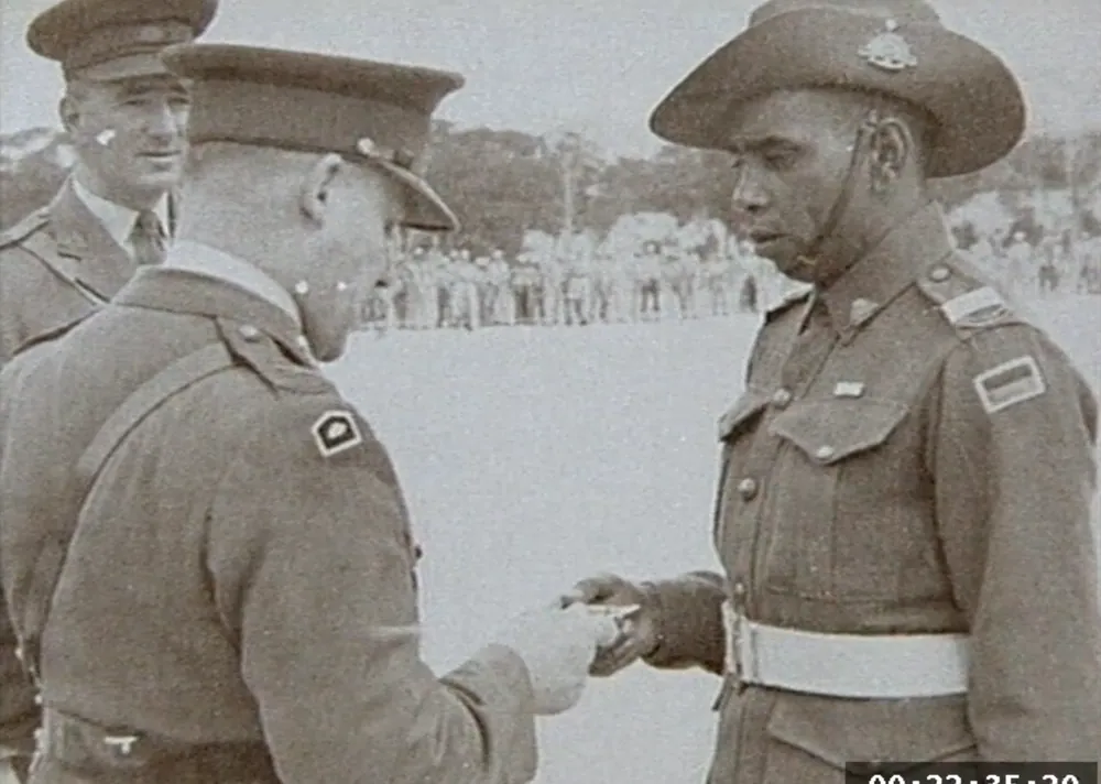 An officer inspected on parade during the Korean War era.
