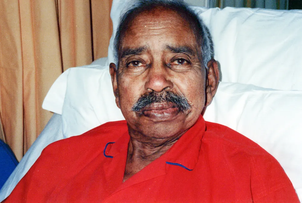 Seated portrait in a red shirt.