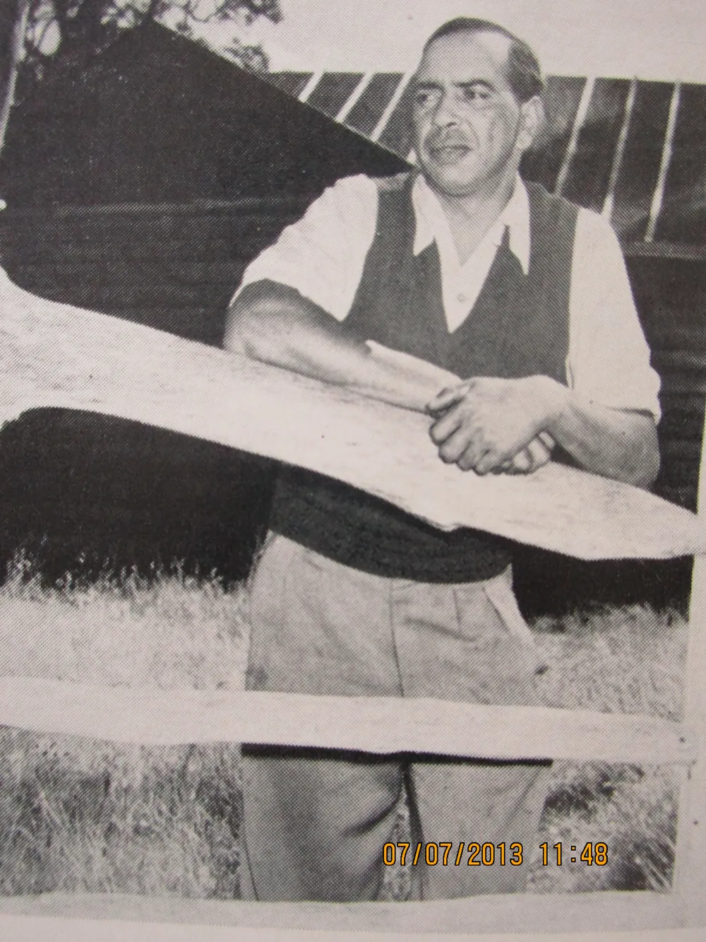 A man beside a surf boat.