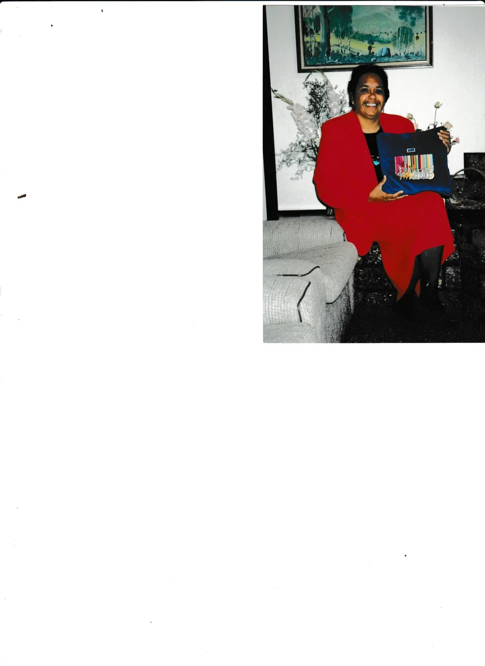 Holding a framed family photograph.