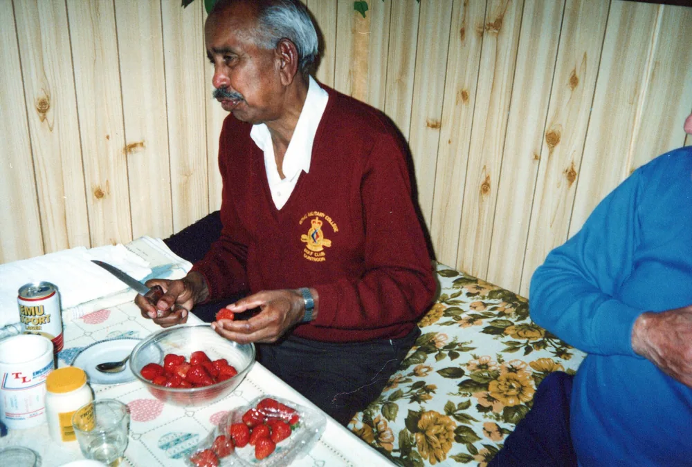 Seated at a table set for a meal.