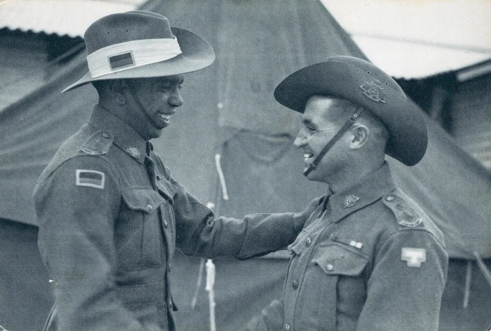 Two soldiers shaking hands.