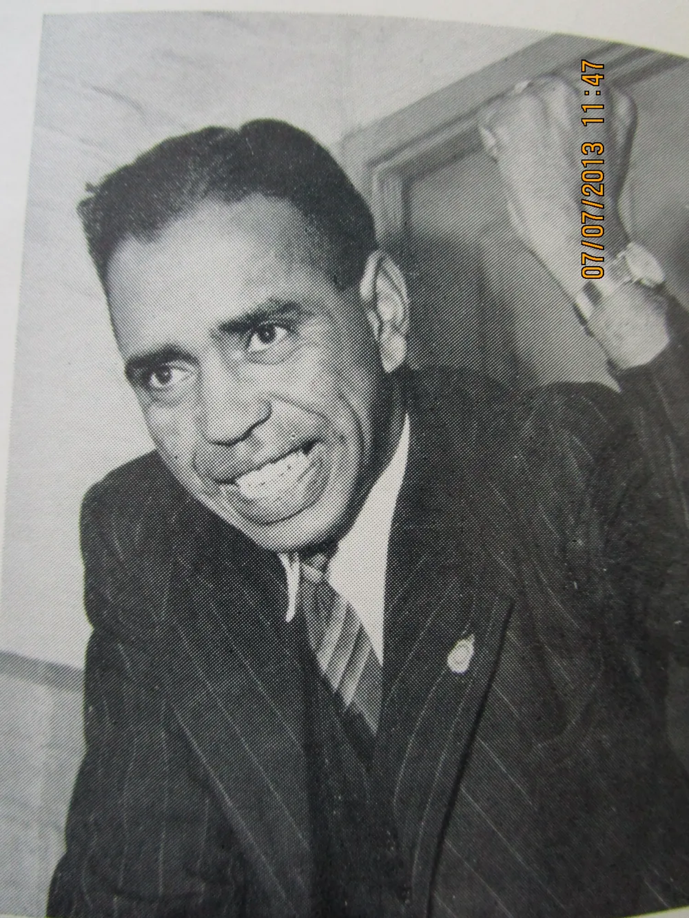 Portrait in a suit at a doorway.
