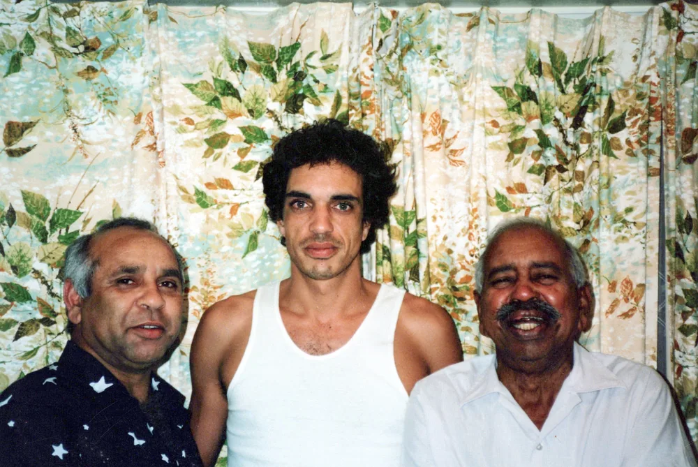 Three men photographed together.
