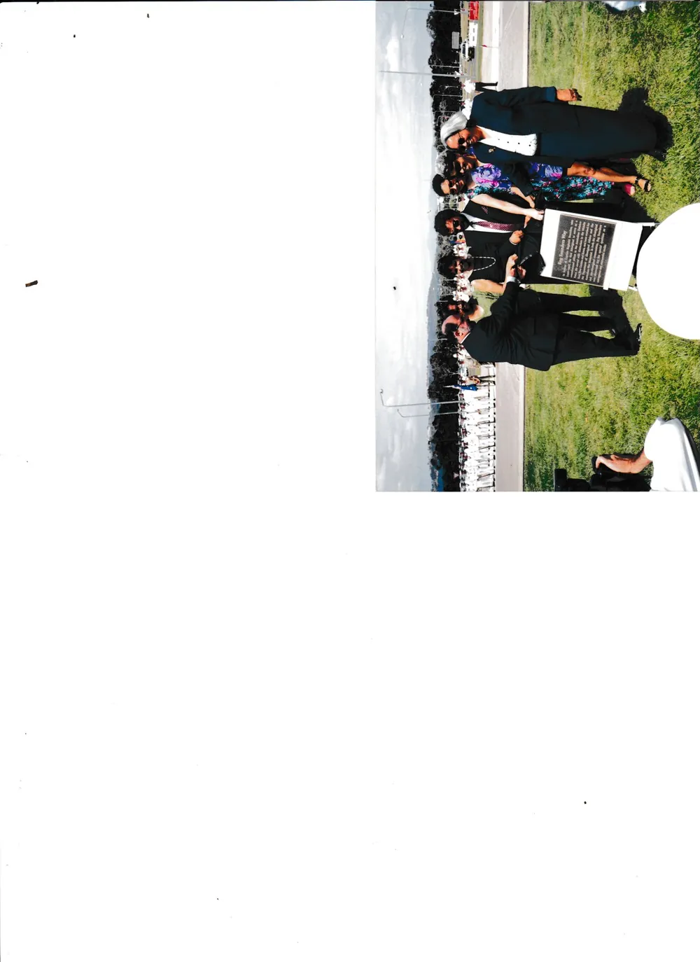 A group on the grass, small print.